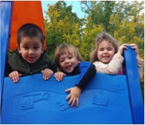 Three student at the top of a blue slide