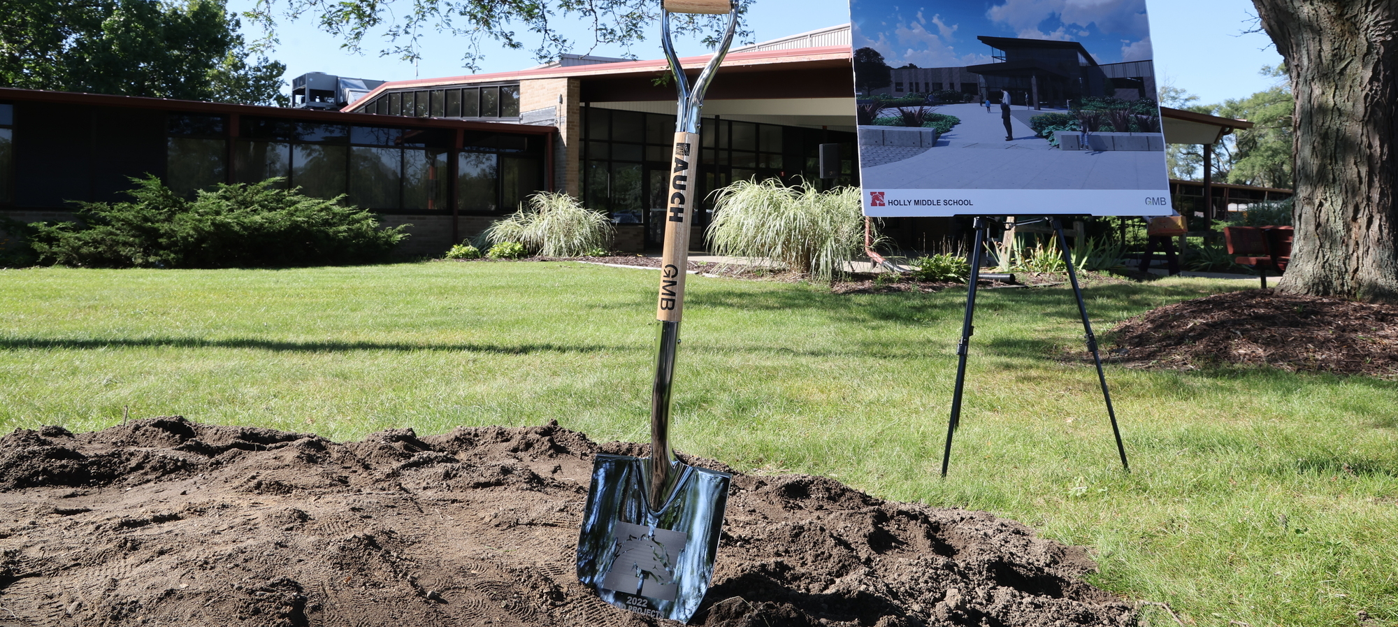 Shovel in dirt for ground breaking for new middle school